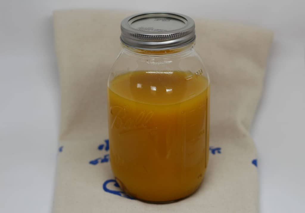 A strained and bottled jar of Fire Cider.
