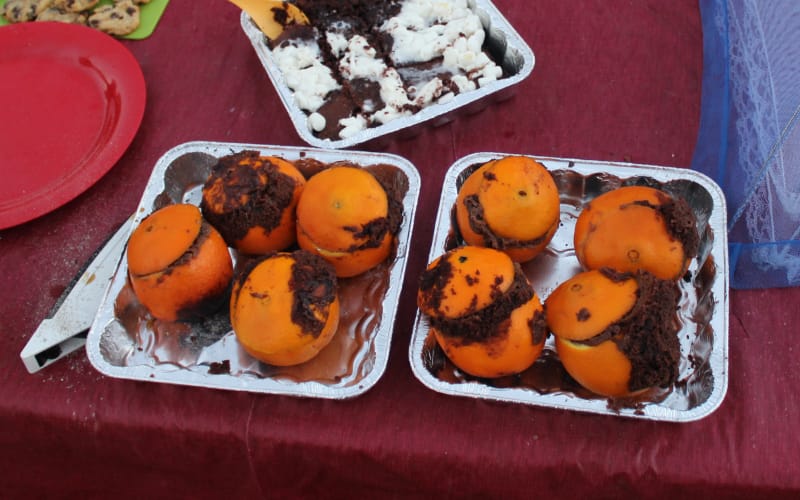 Chocolate Cake in Oranges on a picnic table.