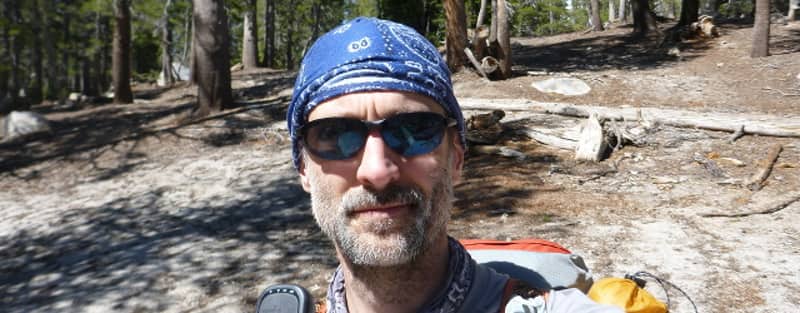 Man wearing a UV Buff and a pair of Native Dash SS sunglasses.