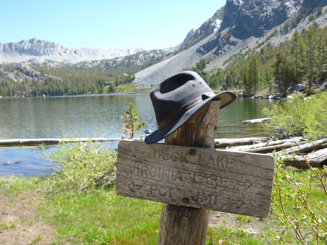 Trail sign at Purple Lake, with hat.