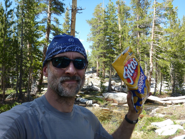 The author brandishing a bag of Fritos.