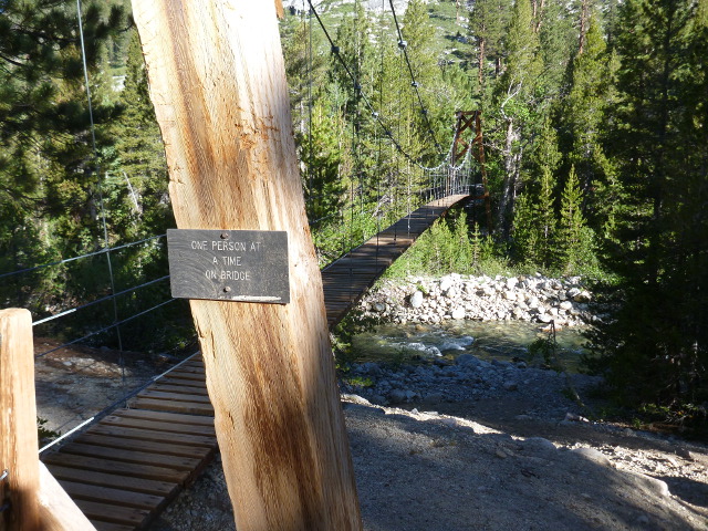 Sign on a bridge reading One person at a time on bridge.